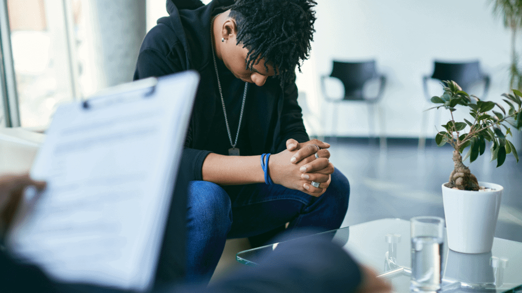Young woman in a support group or counseling session at Destiny Recovery Center.